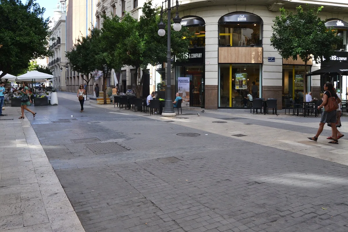 The tree-lined Passeig de Russafa with cafe terraces and pedestrians