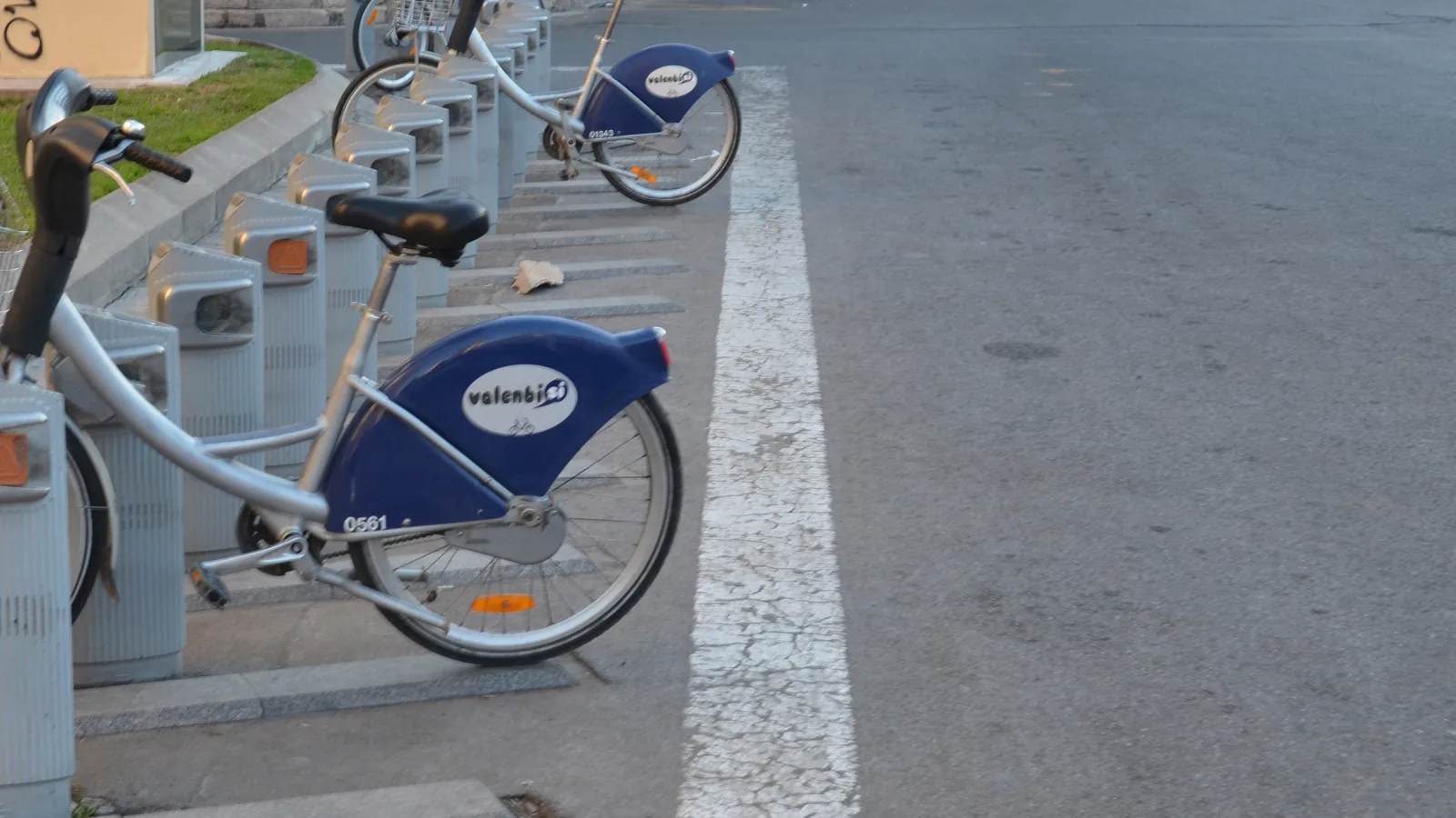 Blue Valenbisi bicycles docked at a bike-share station in Valencia