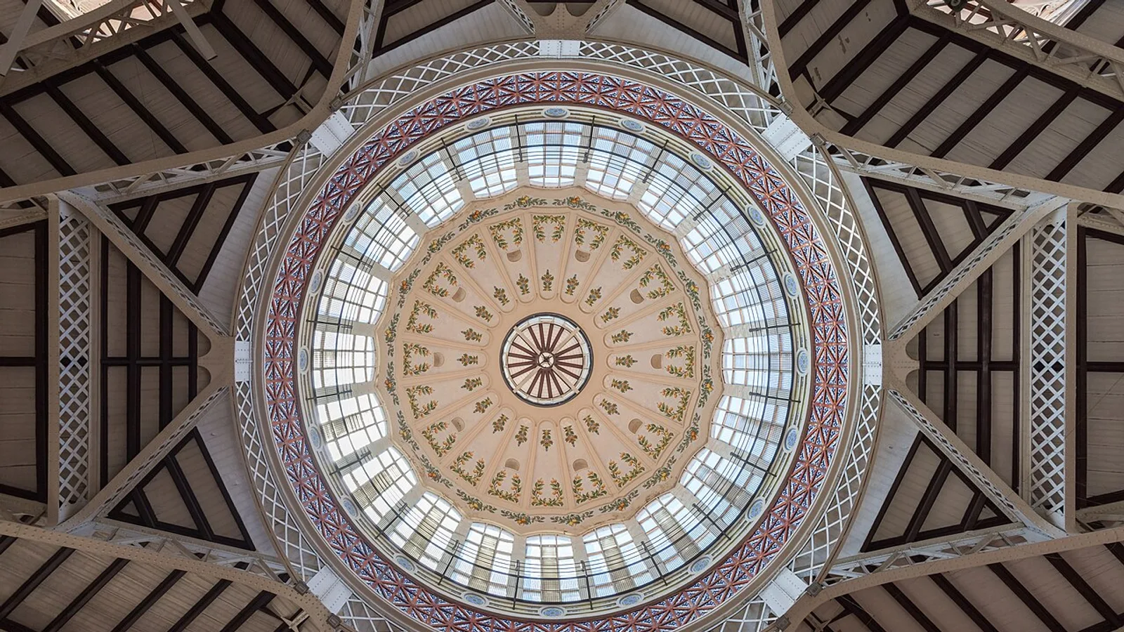Looking straight up into the ornate glass and ironwork dome of Valencia's modernist central market