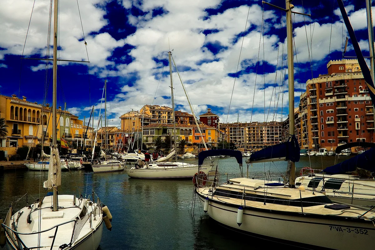 Boats moored beside the colorful canal-side houses of Port Saplaya