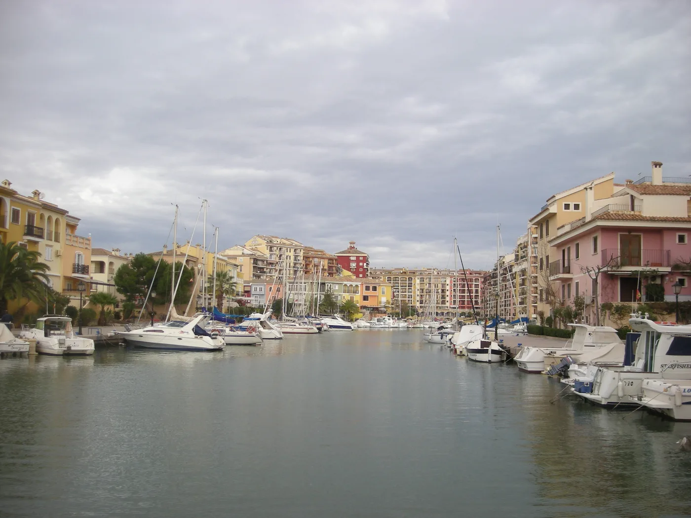 Port Saplaya's inner harbour seen from Plaça del Mercat, boats lining both canal banks