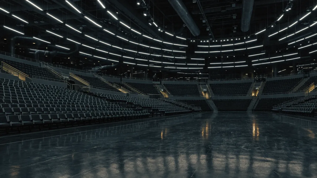 Interior of a modern indoor arena with tiers of empty seats