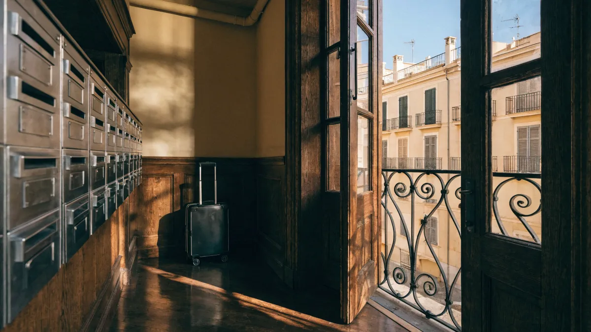 Rolling suitcase in the entrance hall of a Valencia apartment building