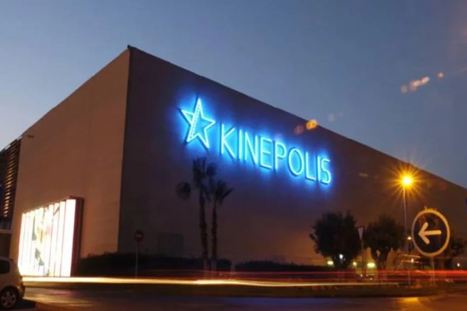 The blue neon KINEPOLIS sign on the Kinepolis Valencia cinema in Paterna at dusk