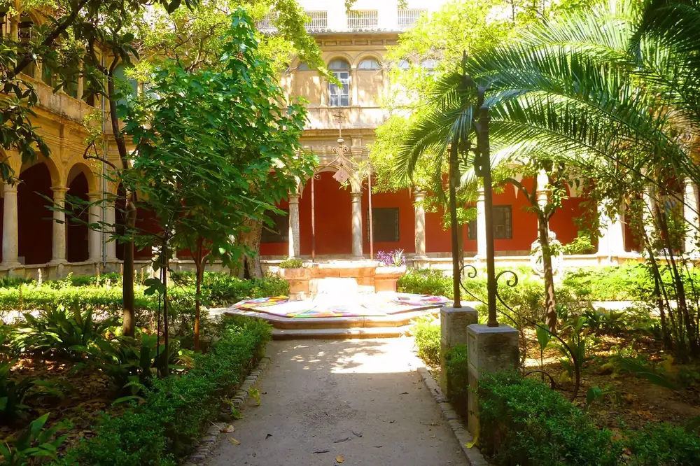 The planted cloister garden of the Centre del Carme in El Carmen, Valencia, with palms and arcades