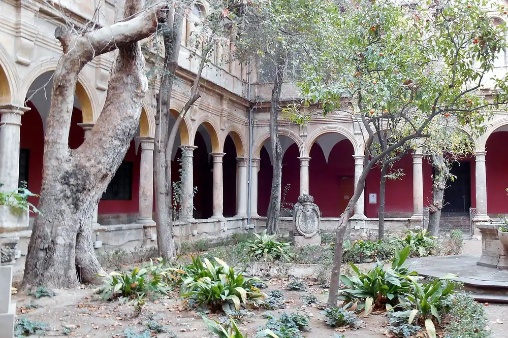 The Renaissance cloister of the Centre del Carme in El Carmen, Valencia, with orange trees and red arcades