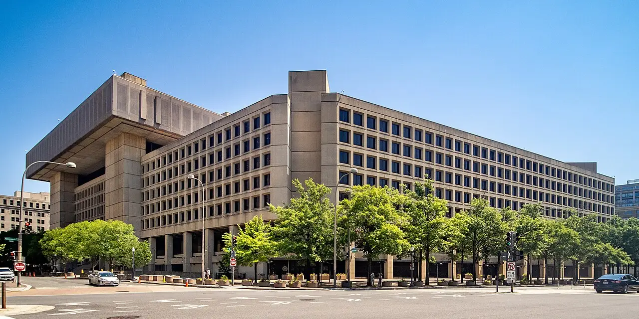 The J. Edgar Hoover Building in Washington, D.C., the long-time headquarters of the FBI, seen from the street behind a row of trees