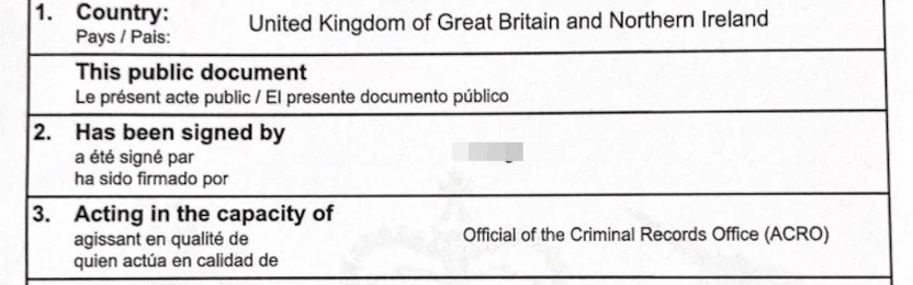 A UK apostille certificate showing the country as the United Kingdom of Great Britain and Northern Ireland and the signatory acting as an official of the Criminal Records Office (ACRO), with the personal details redacted