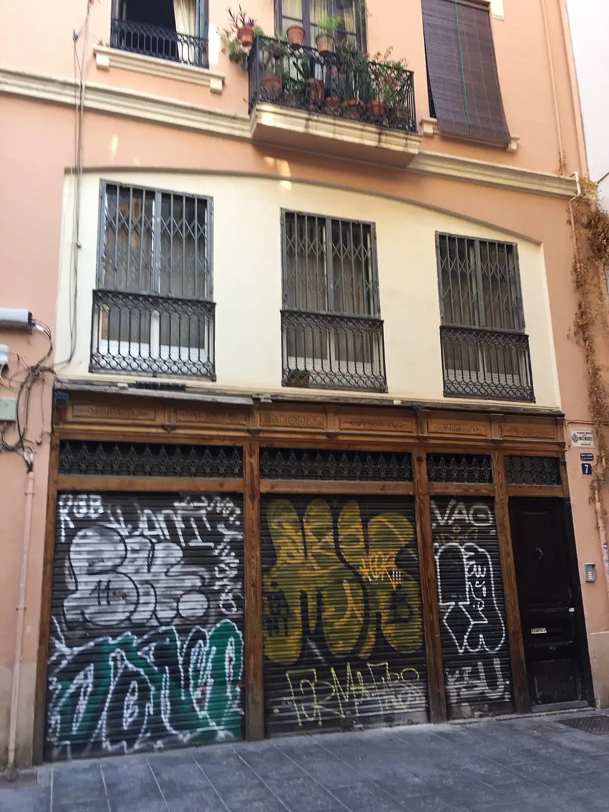 Mid-rise apartment blocks on Carrer de la Tapineria in Valencia, each with its own ground-floor doorway and multiple floors of flats