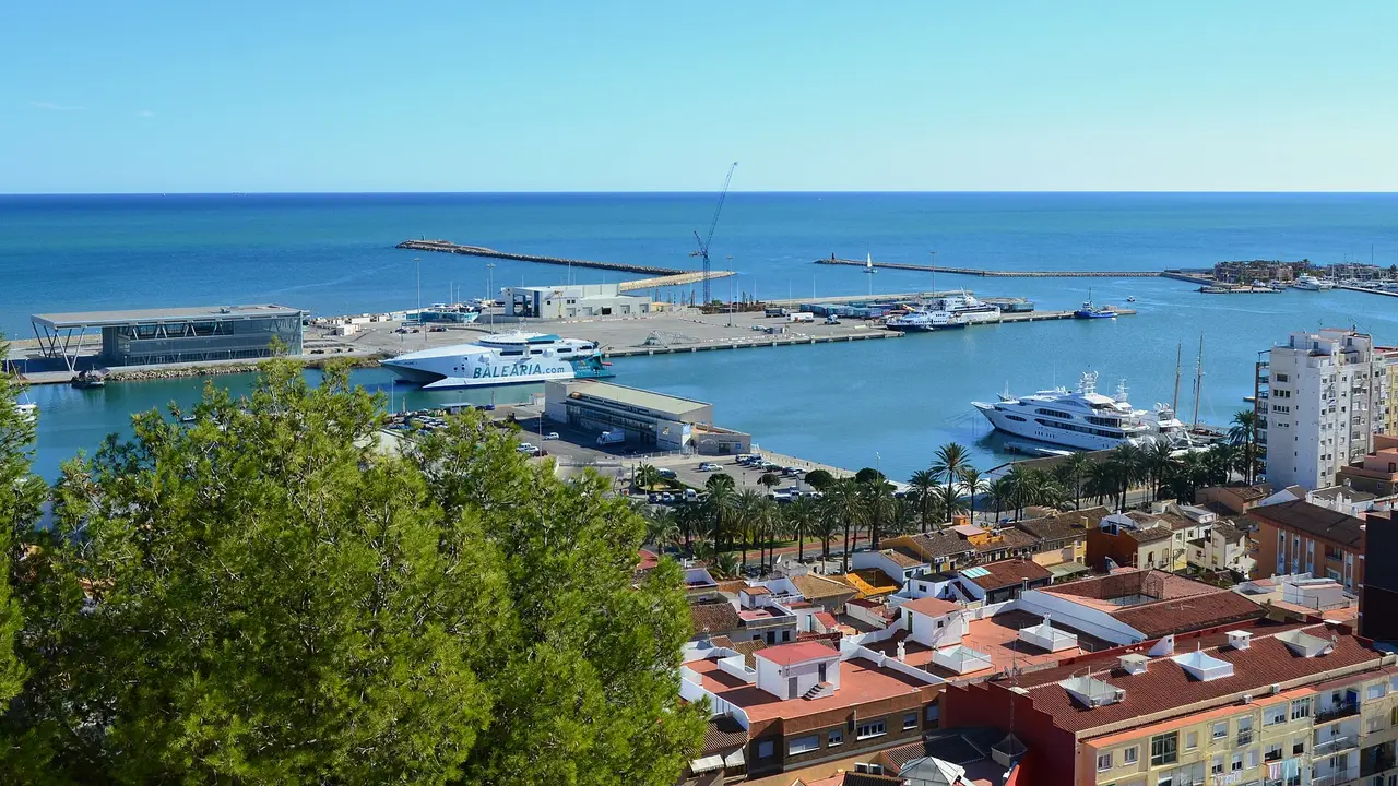 The port of Dénia seen from the castle, with a ferry at the quay, the passenger terminal, yachts and the town's rooftops