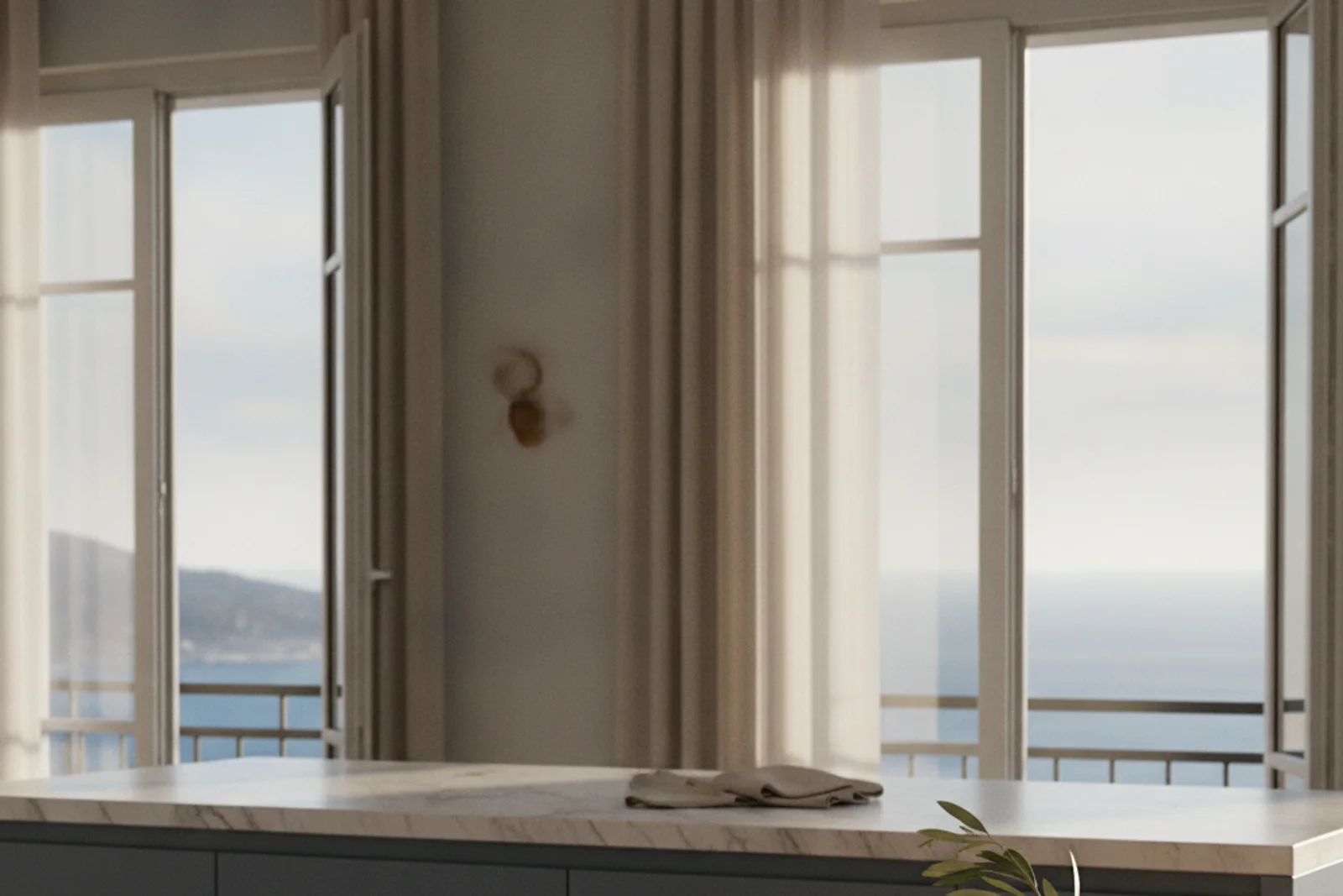 Une cuisine d'appartement impeccable et ensoleillée avec du linge propre plié et des clés sur le plan de travail, prête pour l'emménagement
