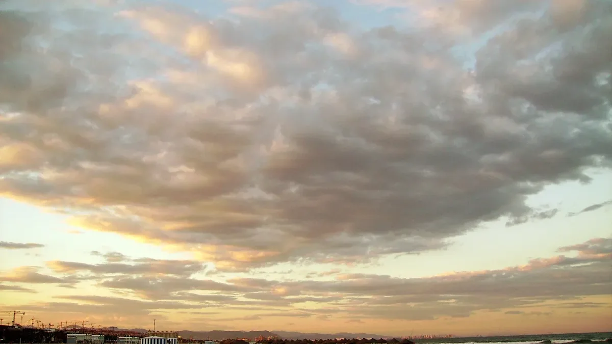 Malvarrosa beach in Valencia at dusk with two small boats on the sand