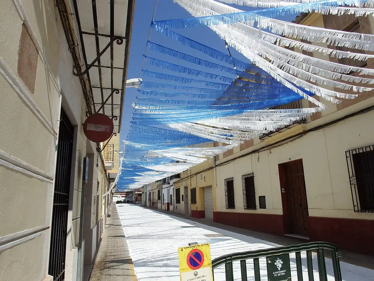 A residential street in Bétera hung with colourful festival bunting