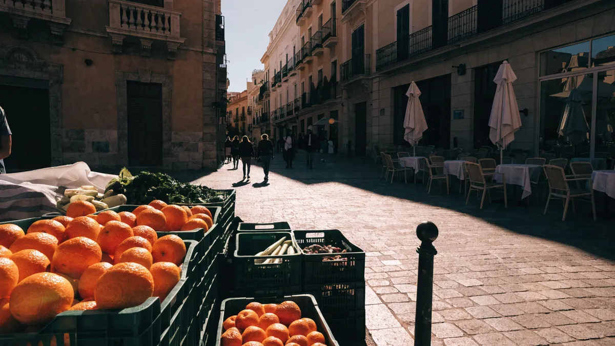 Morning market stall in a Valencia plaza with fresh produce