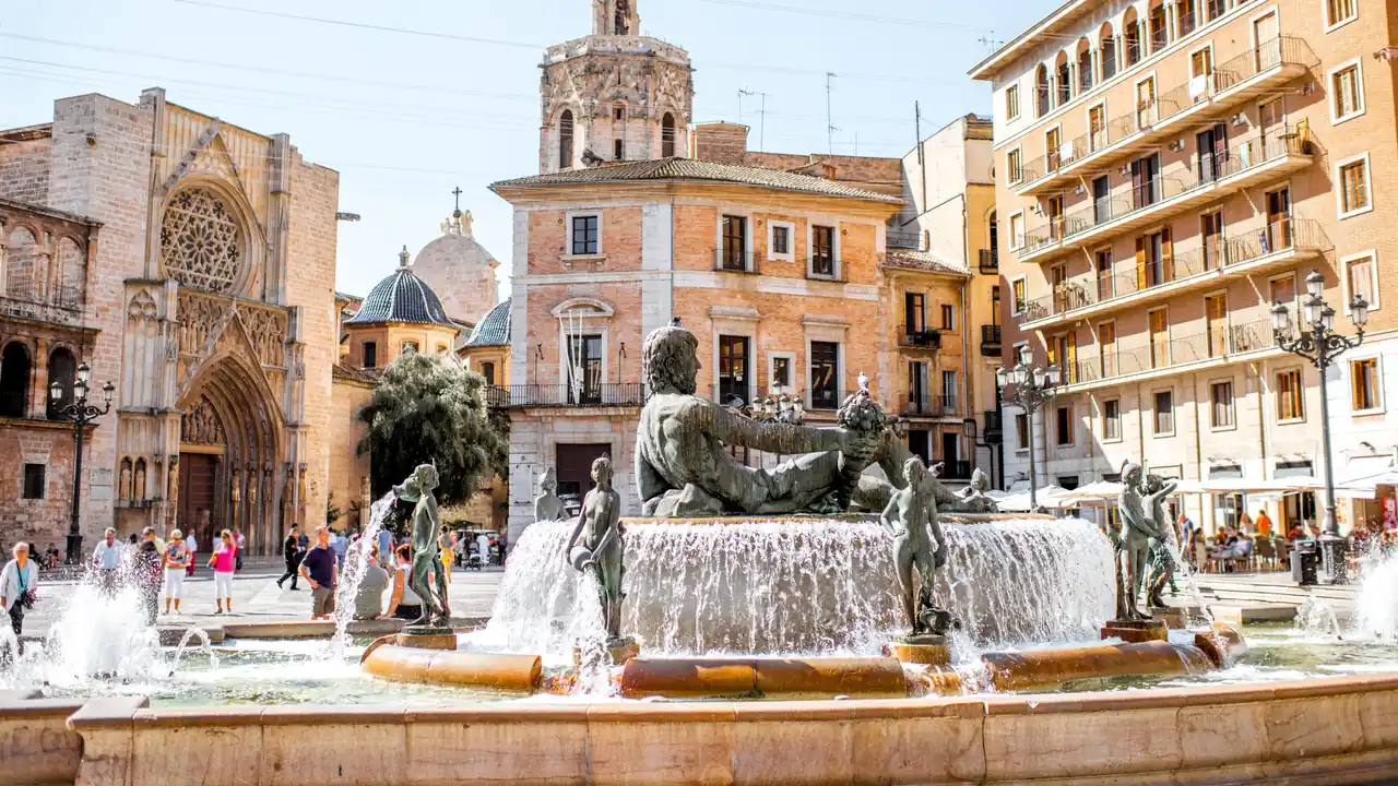 Plaza de la Virgen in Valencia with the cathedral and the Turia fountain in afternoon sun